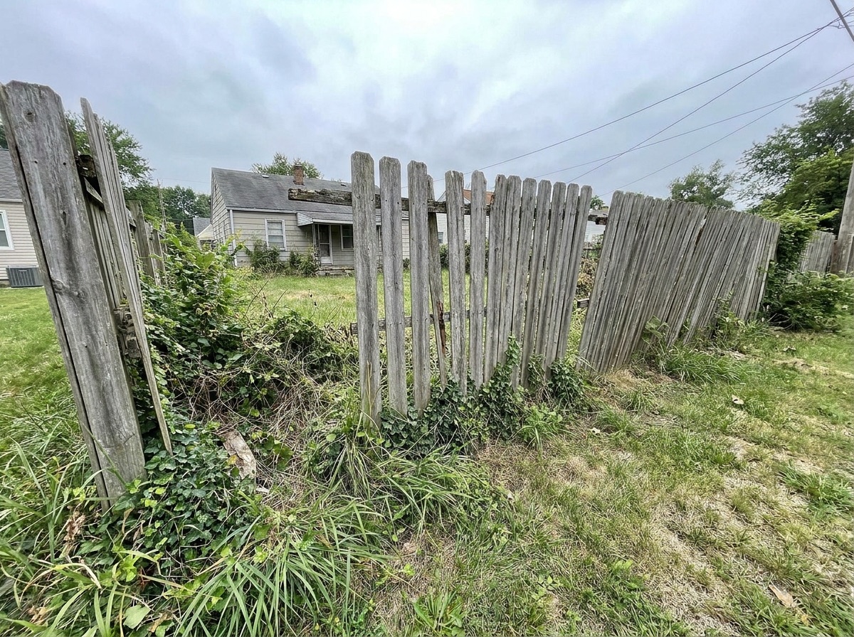 Rotted wood fence before replacement